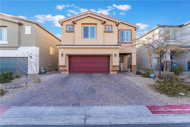 mediterranean / spanish-style home with a garage