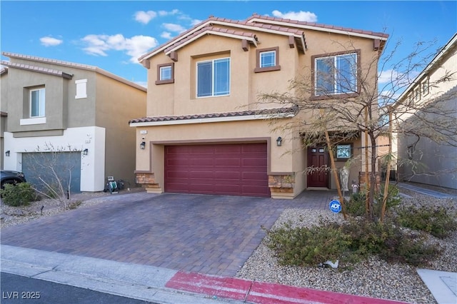 mediterranean / spanish house with a garage