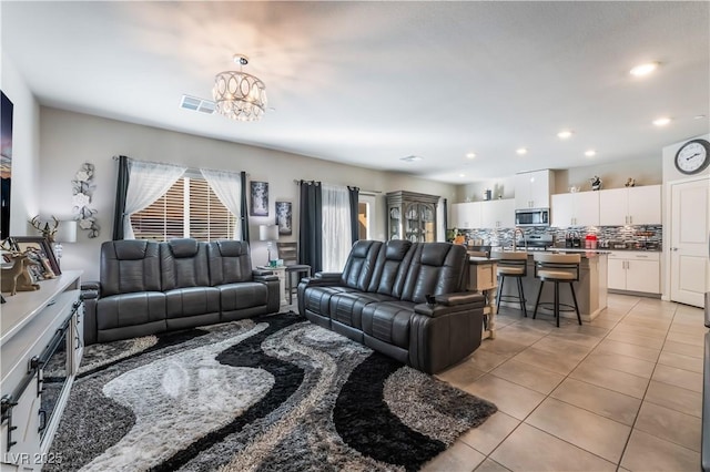 tiled living room with an inviting chandelier