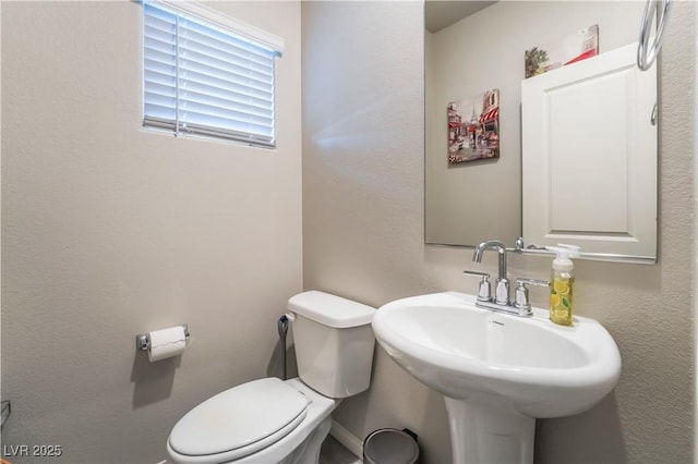 bathroom featuring toilet and sink