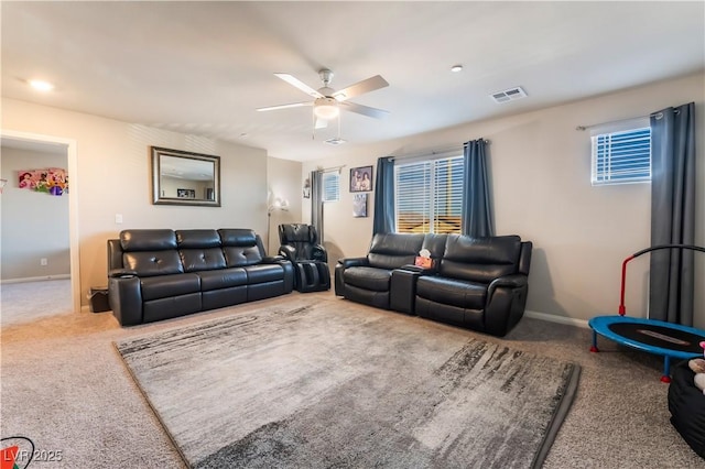 carpeted living room with ceiling fan