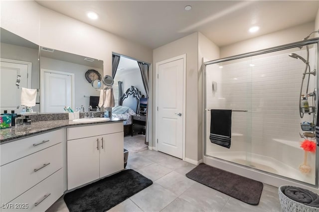 bathroom featuring tile patterned flooring, vanity, and walk in shower