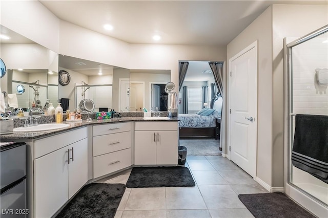 bathroom featuring vanity, an enclosed shower, and tile patterned floors