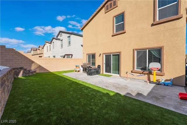 back of house featuring a patio area and a lawn