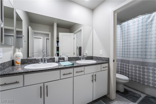 bathroom with vanity, tile patterned flooring, and toilet