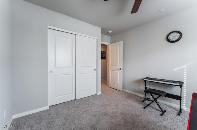 unfurnished bedroom with ceiling fan, light carpet, and a closet