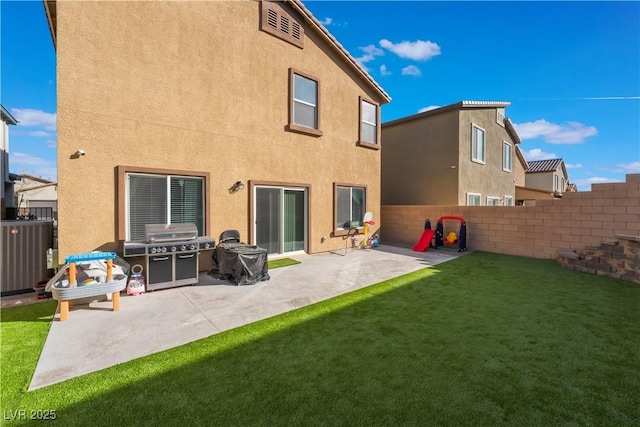 back of house featuring a patio area and a lawn