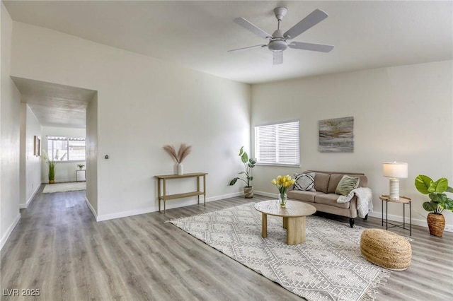 living room featuring ceiling fan and light hardwood / wood-style floors