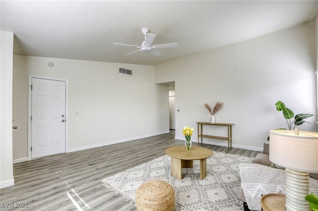 sitting room featuring vaulted ceiling, light hardwood / wood-style floors, and ceiling fan