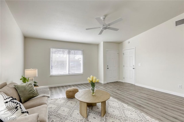 living room with ceiling fan and hardwood / wood-style floors