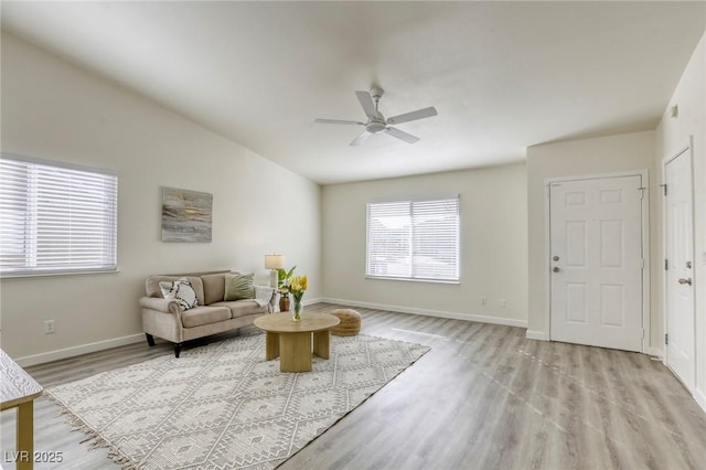 living room featuring ceiling fan and light hardwood / wood-style flooring