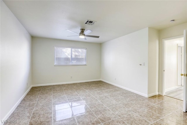 tiled spare room with ceiling fan