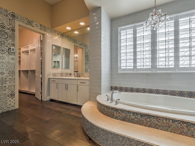 3 Pine Hollow Dr, Henderson, NV 89052 - full bath featuring vanity, hardwood / wood-style floors, a garden tub, a chandelier, and a walk in closet