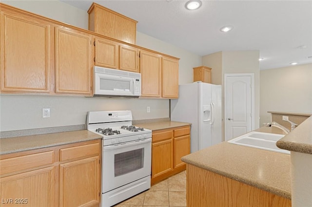 kitchen featuring sink, light brown cabinets, white appliances, and light tile patterned floors