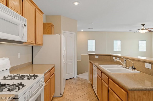 kitchen featuring ceiling fan, sink, light tile patterned floors, and white appliances