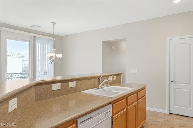 kitchen with pendant lighting, white dishwasher, sink, and light tile patterned floors