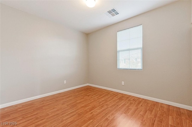 unfurnished room with light wood-type flooring