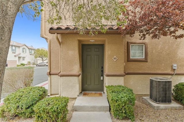 doorway to property featuring central AC unit