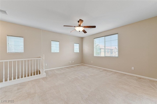 unfurnished room featuring ceiling fan and light colored carpet