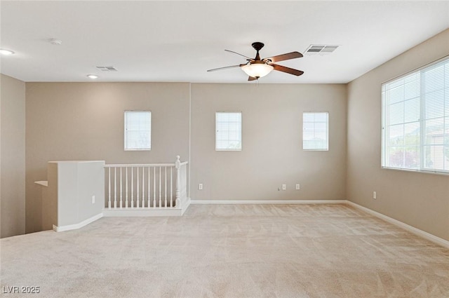 unfurnished room featuring light colored carpet