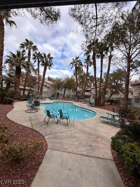 view of swimming pool featuring a patio area