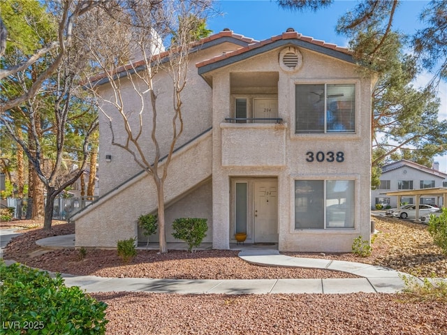 view of front of home with a tile roof and stucco siding