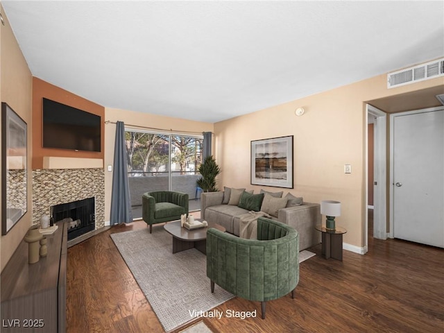 3038 Casey Dr Unit 204, Las Vegas, NV 89120 - living area featuring wood finished floors, a tiled fireplace, and baseboards