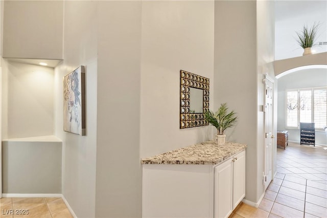 hallway featuring light tile patterned floors