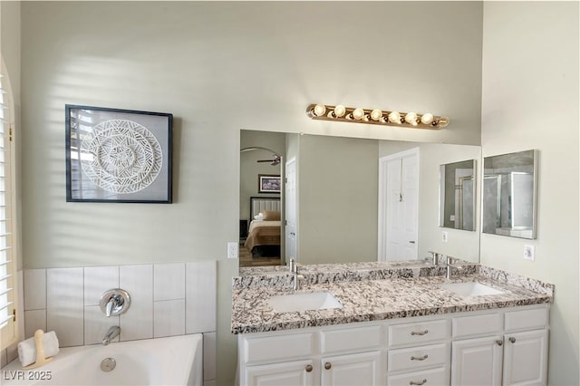 bathroom with vanity and a bath