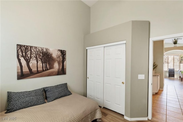 bedroom featuring a towering ceiling and a closet