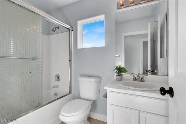 full bathroom with toilet, vanity, and bath / shower combo with glass door