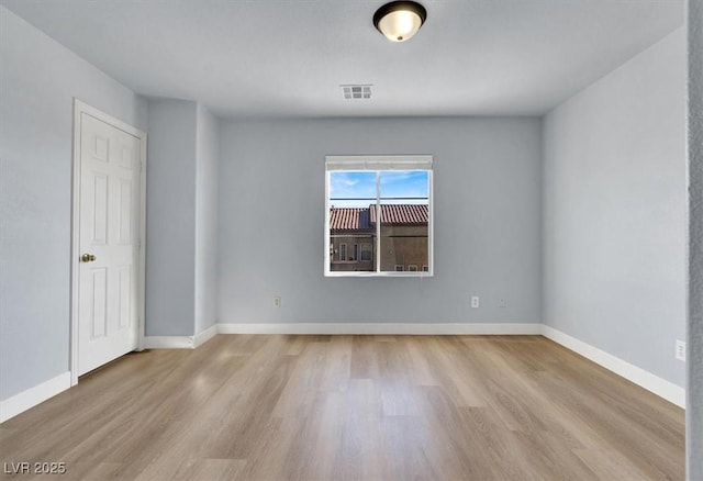 unfurnished room with light wood-type flooring