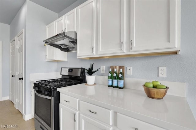 kitchen featuring gas range and white cabinetry