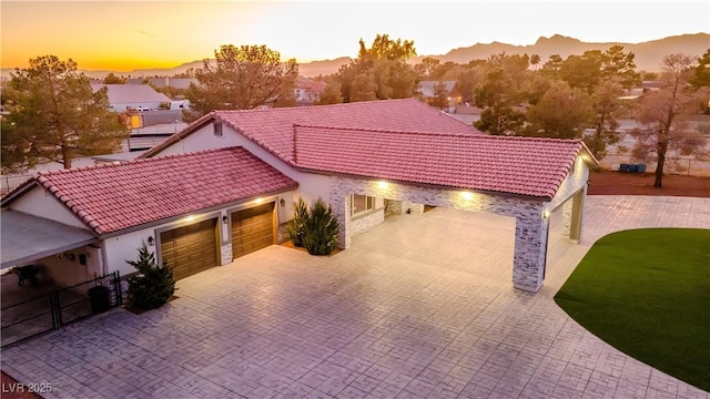 view of front of home with a garage, a mountain view, and central air condition unit