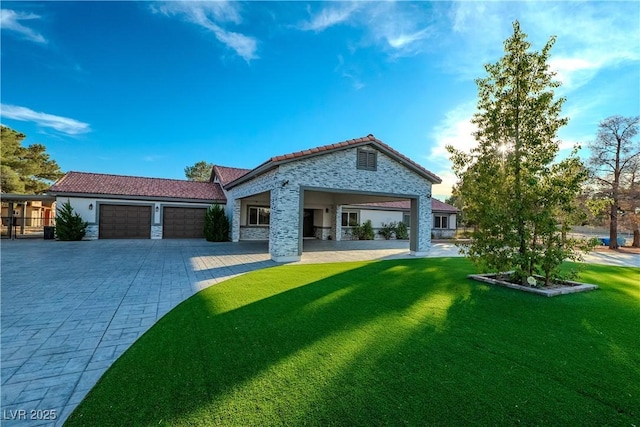 view of front of home featuring a garage and a front lawn