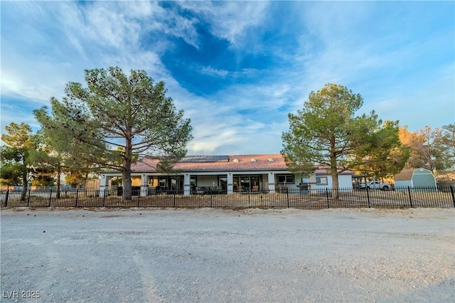 view of front of property with solar panels