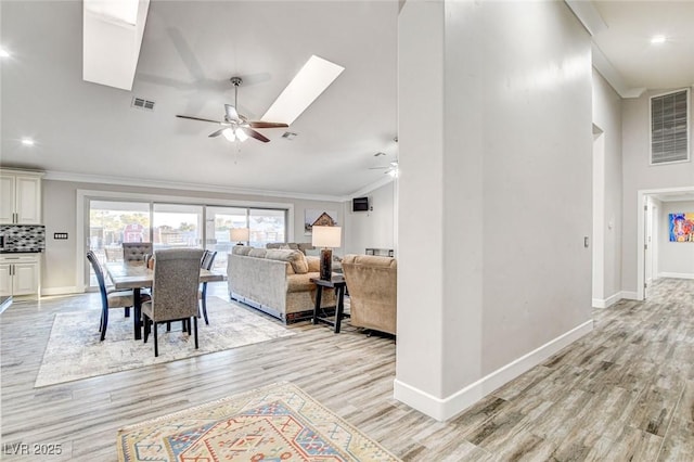 interior space with crown molding, high vaulted ceiling, ceiling fan, and light wood-type flooring