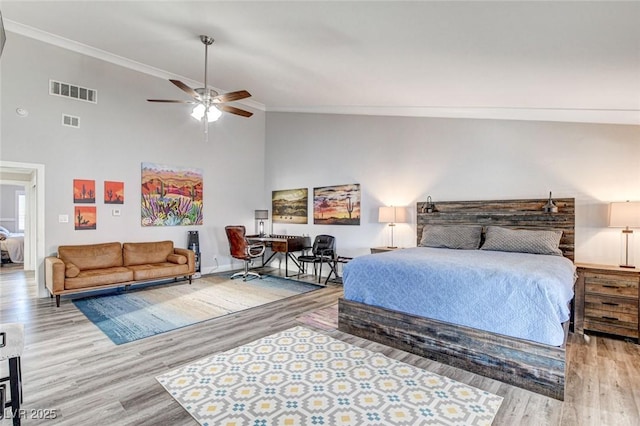 bedroom featuring ornamental molding, high vaulted ceiling, ceiling fan, and light hardwood / wood-style floors