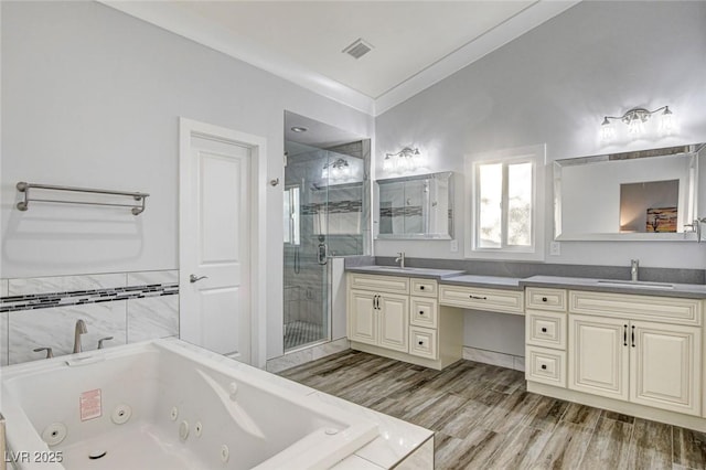 bathroom featuring hardwood / wood-style flooring, vanity, crown molding, and separate shower and tub