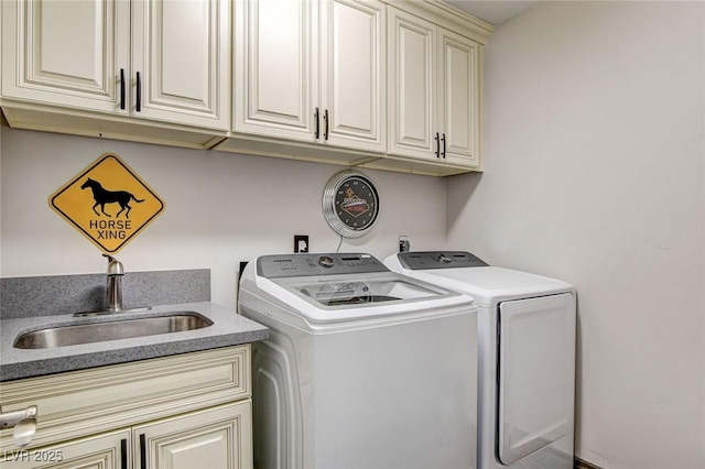 laundry room with cabinets, sink, and washing machine and clothes dryer