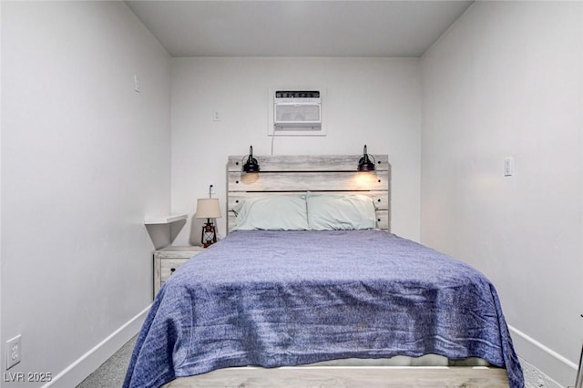 bedroom featuring carpet flooring and a wall unit AC