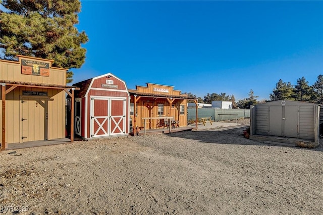 rear view of house with a storage unit