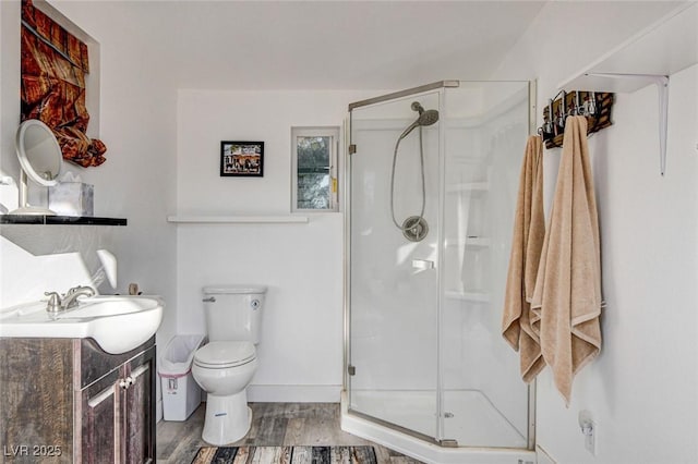 bathroom with vanity, hardwood / wood-style flooring, toilet, and walk in shower