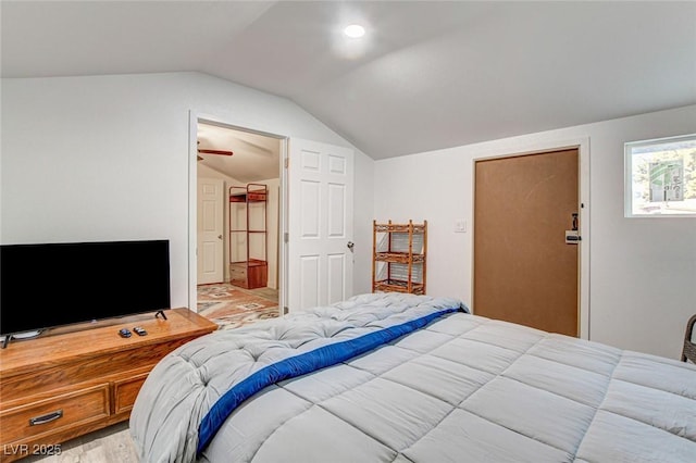 bedroom with vaulted ceiling and light hardwood / wood-style floors