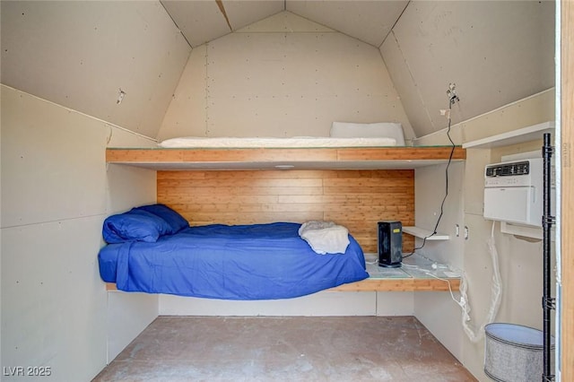 bedroom with vaulted ceiling and concrete floors