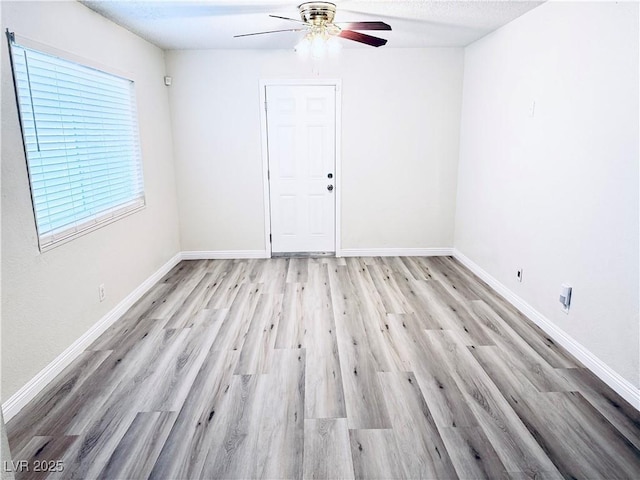 unfurnished room featuring ceiling fan and light wood-type flooring