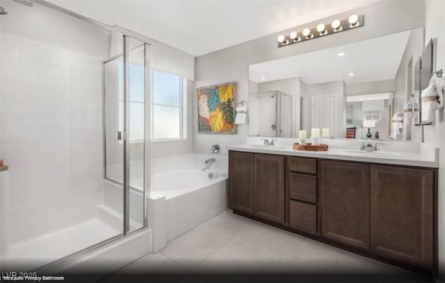 bathroom with independent shower and bath, vanity, and tile patterned floors