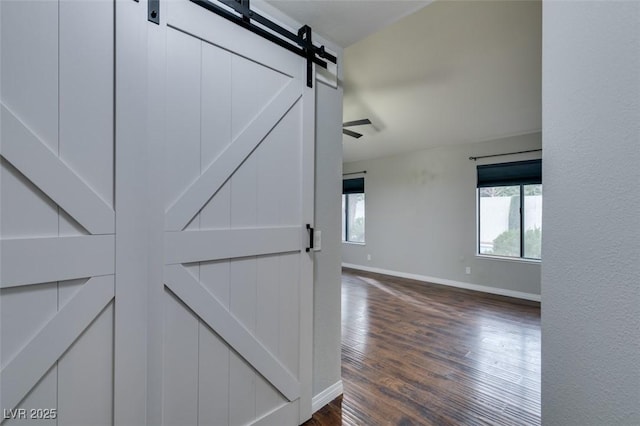 details with a barn door and hardwood / wood-style floors