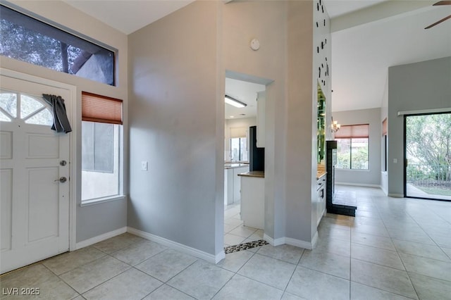 foyer featuring light tile patterned floors and a wealth of natural light