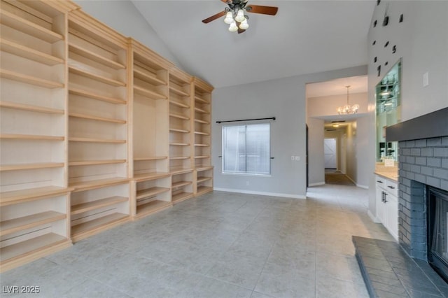 unfurnished living room featuring ceiling fan with notable chandelier, vaulted ceiling, and a brick fireplace